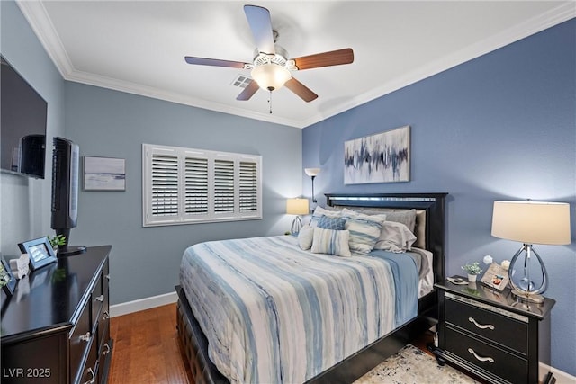 bedroom with crown molding, wood finished floors, a ceiling fan, and baseboards