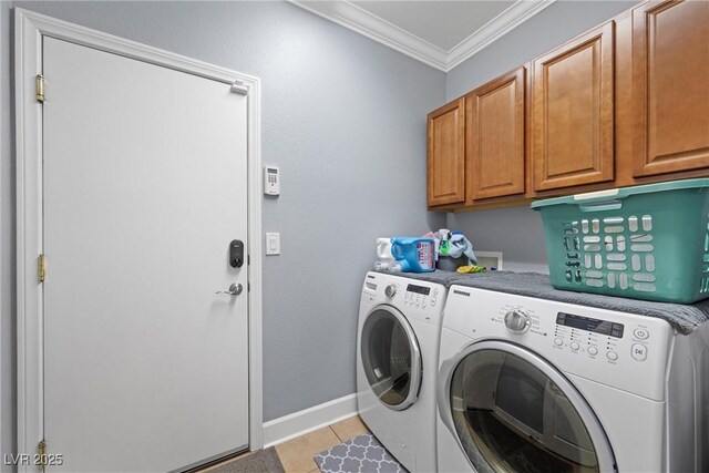 washroom with crown molding, cabinet space, light tile patterned flooring, independent washer and dryer, and baseboards