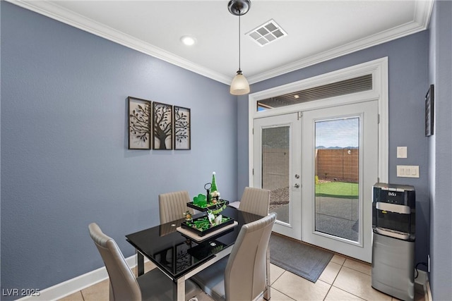 dining area with french doors, visible vents, crown molding, and light tile patterned floors