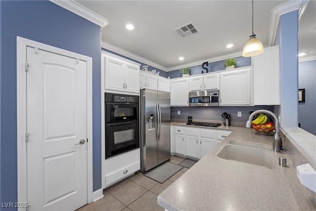 kitchen featuring stainless steel appliances, ornamental molding, a sink, and visible vents