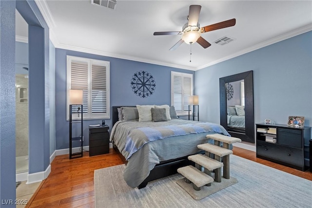 bedroom with visible vents, crown molding, and wood finished floors