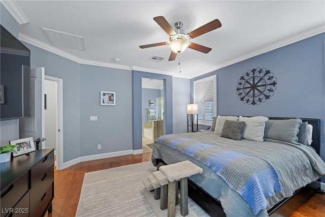 bedroom with baseboards, wood finished floors, visible vents, and crown molding