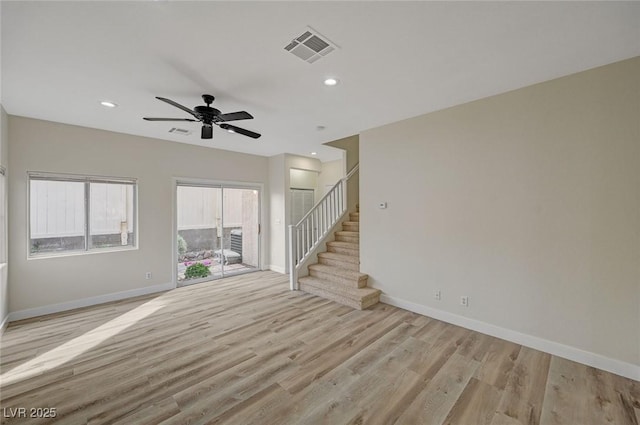 spare room featuring recessed lighting, visible vents, stairway, wood finished floors, and baseboards