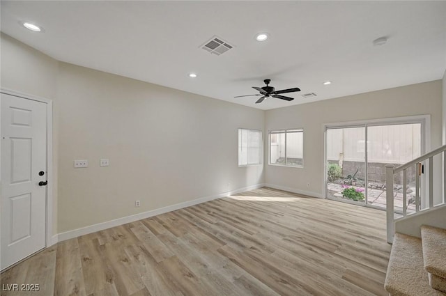 unfurnished living room featuring recessed lighting, visible vents, stairway, light wood-style floors, and baseboards