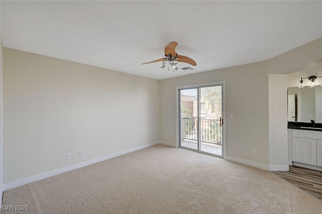 interior space featuring light carpet, visible vents, a ceiling fan, and baseboards