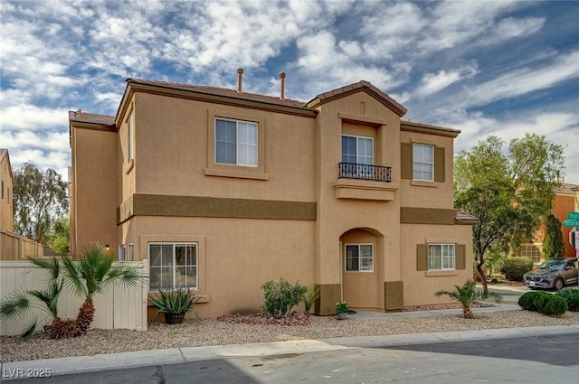 view of front of property with fence and stucco siding