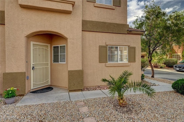 doorway to property with stucco siding