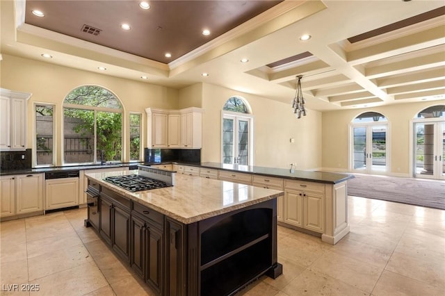 kitchen with tasteful backsplash, a kitchen island, gas cooktop, and french doors