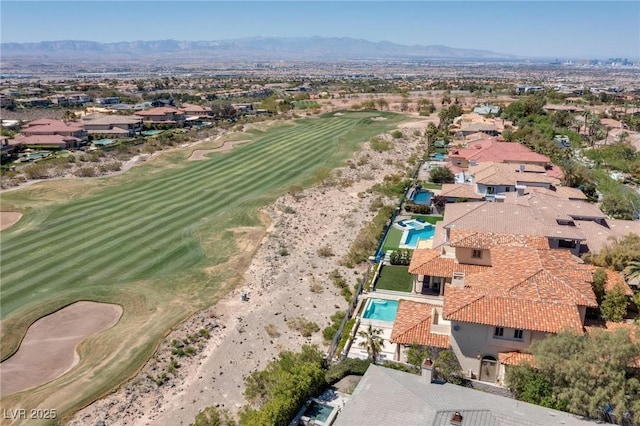 aerial view with a residential view, a mountain view, and golf course view