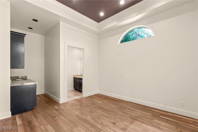 spare room with light wood-type flooring, baseboards, and recessed lighting