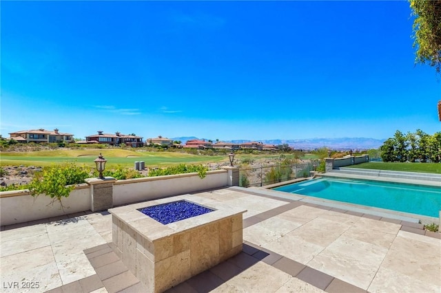 pool with a yard, an outdoor fire pit, and a patio