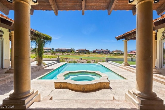 view of swimming pool with a pool with connected hot tub and a patio