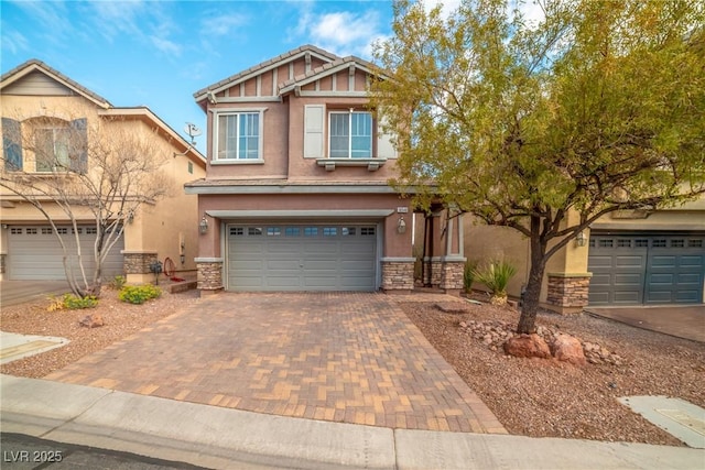 craftsman inspired home featuring stucco siding, stone siding, a garage, and decorative driveway