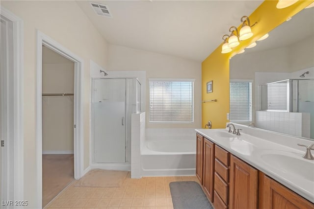 full bathroom with a sink, visible vents, lofted ceiling, and a stall shower