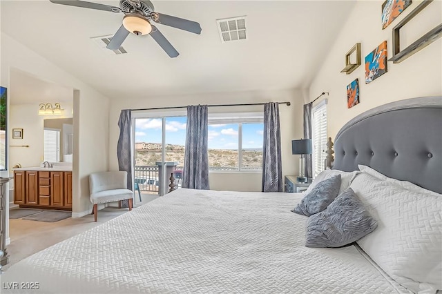 bedroom featuring vaulted ceiling, visible vents, and multiple windows