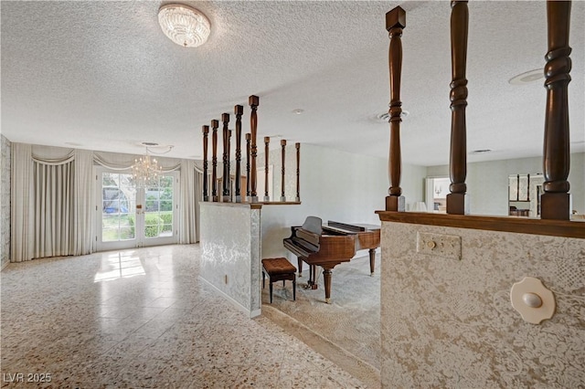 interior space featuring a textured ceiling and an inviting chandelier