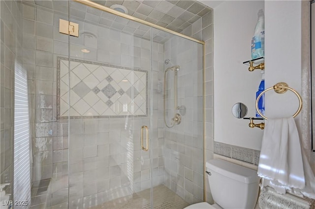 bathroom with a stall shower and toilet