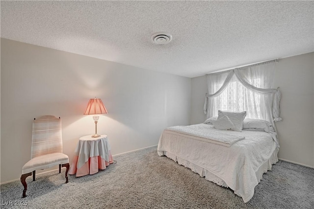 bedroom with a textured ceiling, carpet flooring, and visible vents