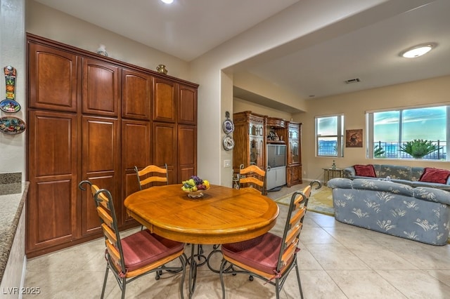 dining area featuring light tile patterned floors and visible vents