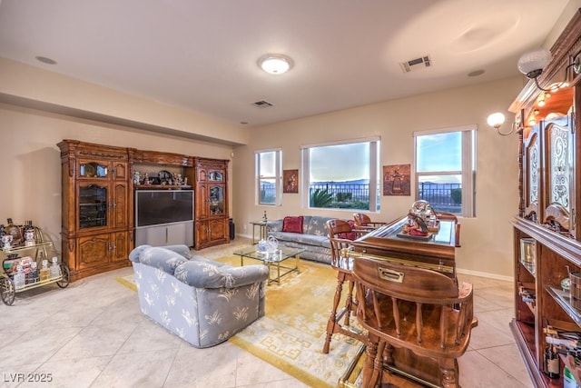 living area featuring visible vents, baseboards, and light tile patterned floors