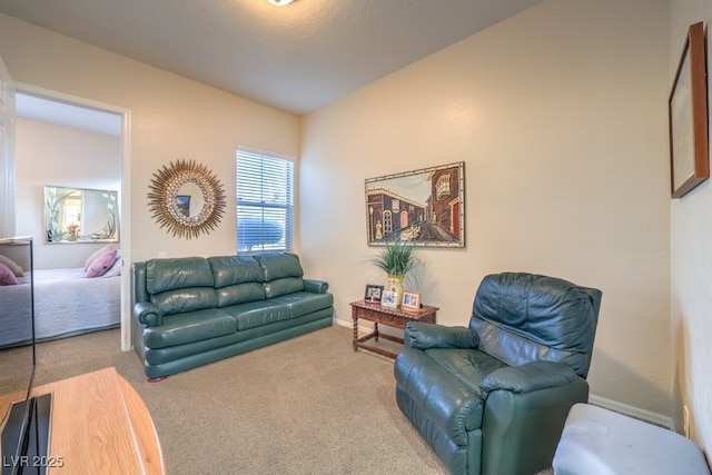 carpeted living room with baseboards