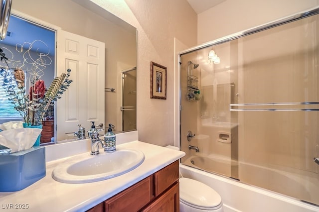 bathroom with toilet, combined bath / shower with glass door, and vanity