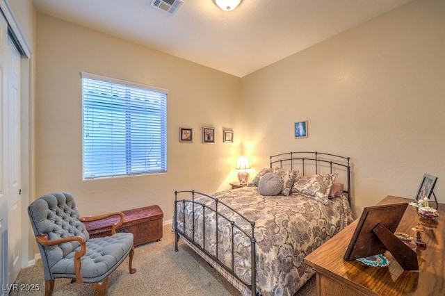 bedroom featuring carpet floors, visible vents, and a closet