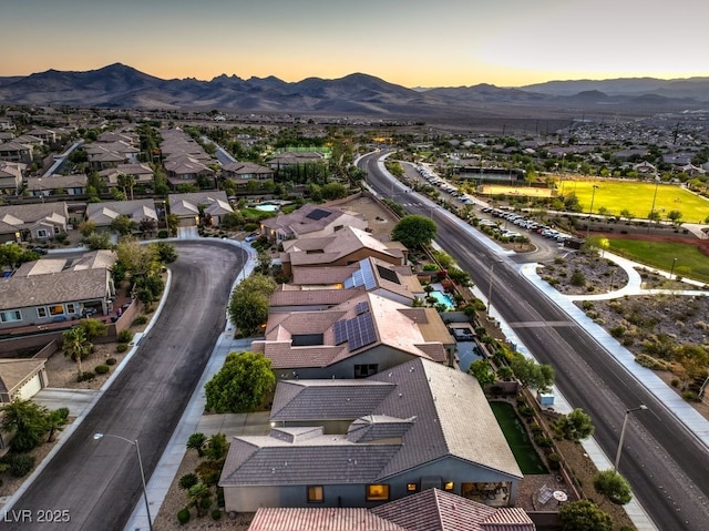 birds eye view of property with a mountain view and a residential view