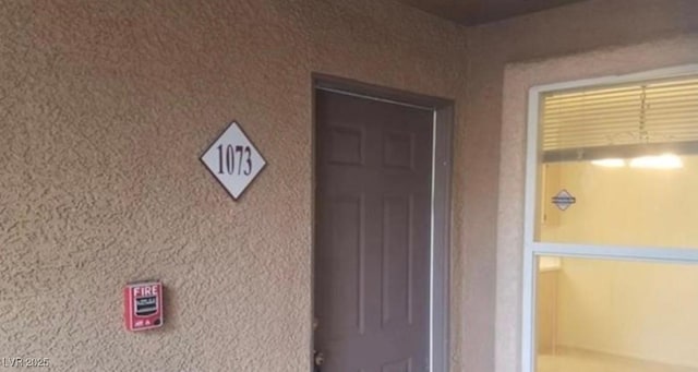 property entrance featuring stucco siding