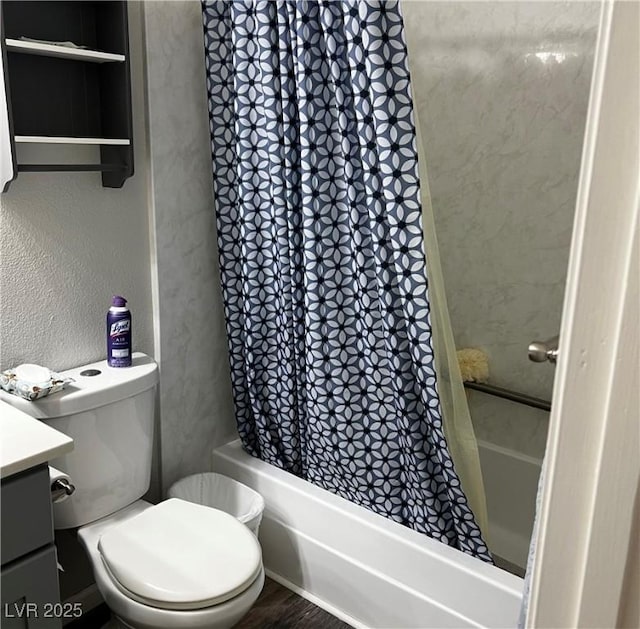 full bathroom with toilet, vanity, shower / bath combo with shower curtain, and a textured wall