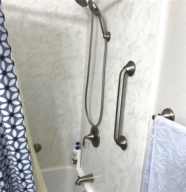 room details featuring shower / tub combo