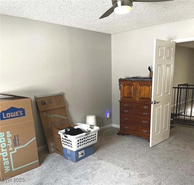 bedroom with a textured ceiling, ceiling fan, carpet flooring, and baseboards