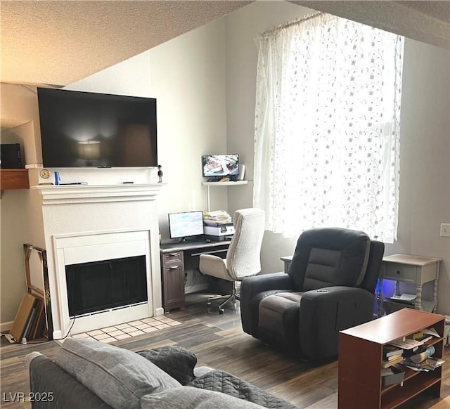 living room with a fireplace with flush hearth and wood finished floors