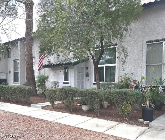 view of front of property with a tiled roof and stucco siding