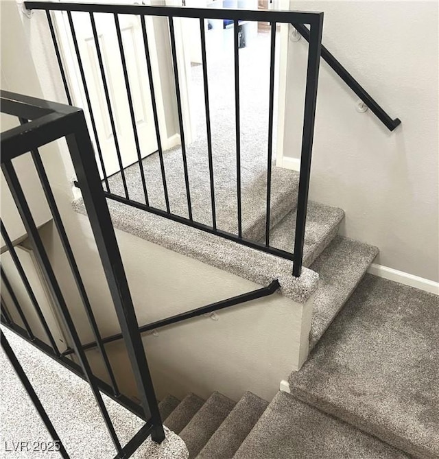 stairway with a wealth of natural light and baseboards