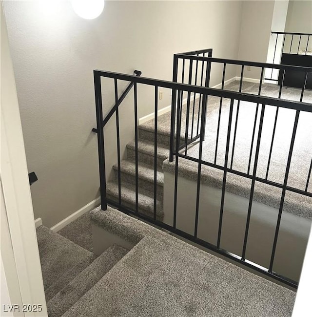 stairway with carpet and baseboards