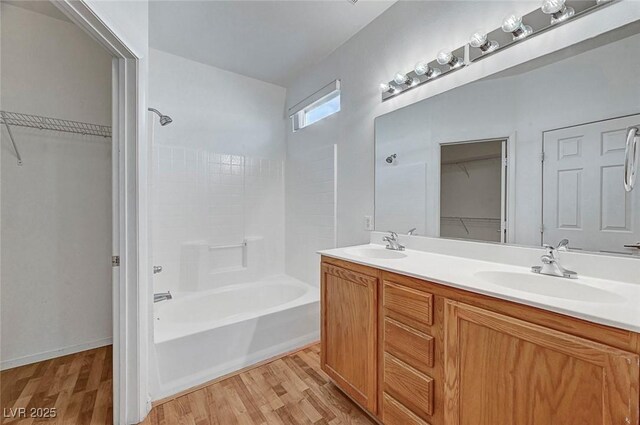 4020 Smokey Fog Ave Unit 201, North Las Vegas, NV 89081 - bathroom with wood finished floors,  shower combination, double vanity, and a spacious closet