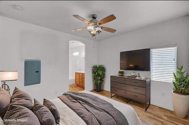 4020 Smokey Fog Ave Unit 201, North Las Vegas, NV 89081 - bedroom with electric panel, arched walkways, light wood-style floors, baseboards, and ensuite bath
