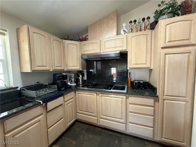 kitchen featuring under cabinet range hood, stovetop with downdraft, light brown cabinets, and a sink