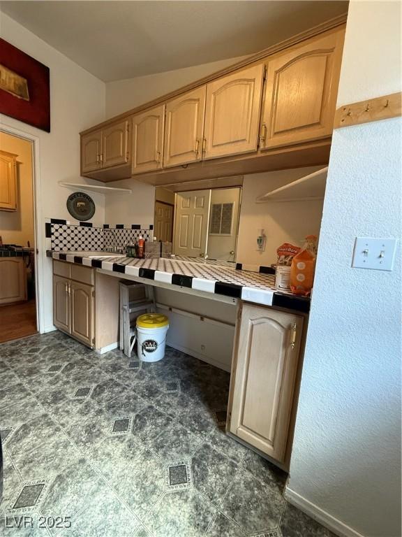 kitchen with tile countertops and backsplash