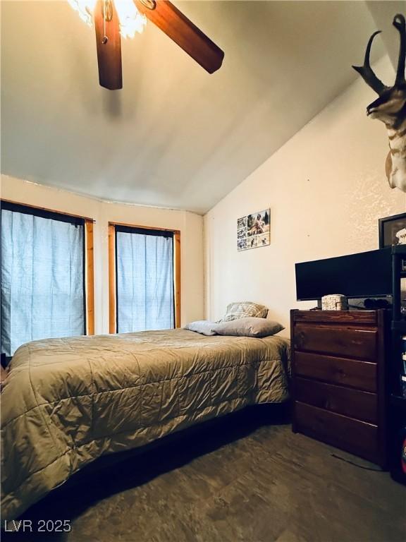 bedroom featuring ceiling fan and vaulted ceiling