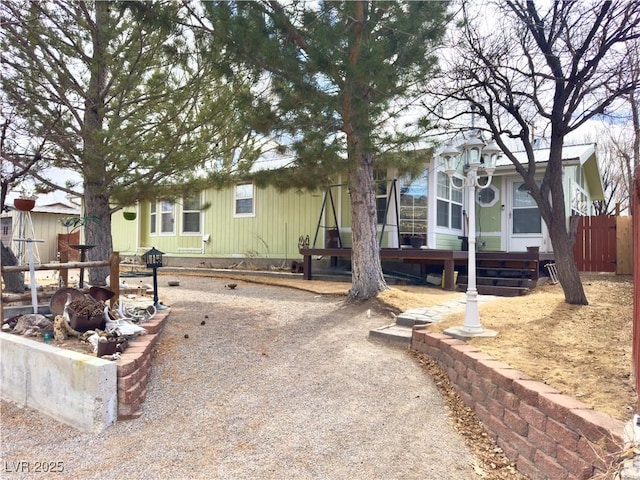 manufactured / mobile home with fence and a wooden deck