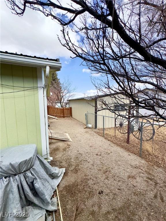 view of yard with an outdoor structure and fence