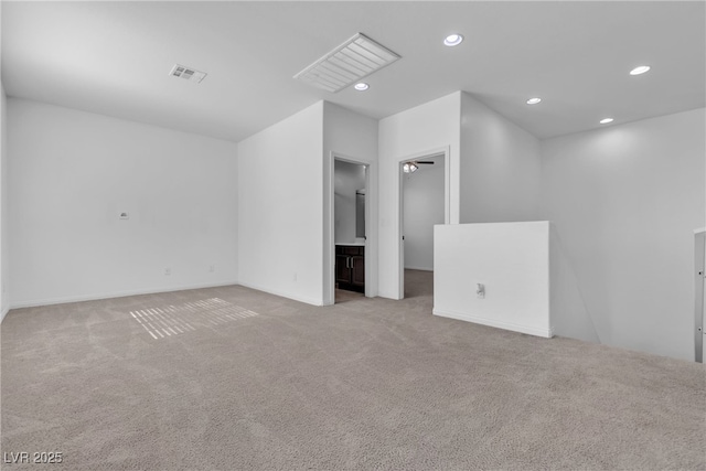 carpeted empty room featuring recessed lighting, visible vents, and baseboards