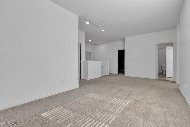 unfurnished room featuring visible vents, recessed lighting, light colored carpet, and baseboards