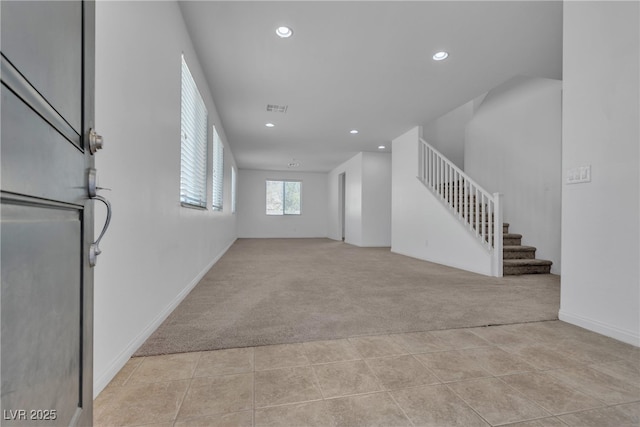 unfurnished living room featuring stairs, recessed lighting, light colored carpet, and visible vents