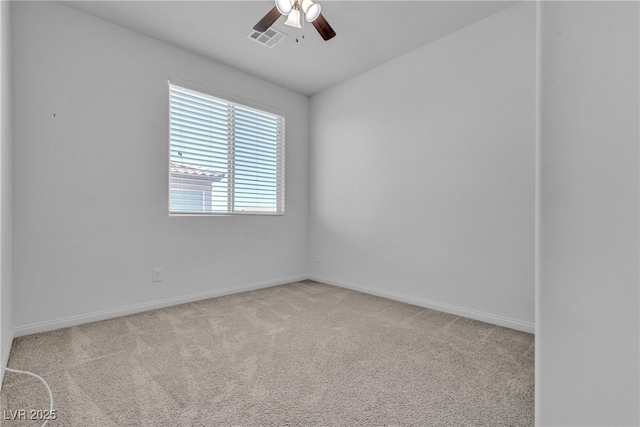 spare room featuring baseboards, visible vents, carpet floors, and ceiling fan