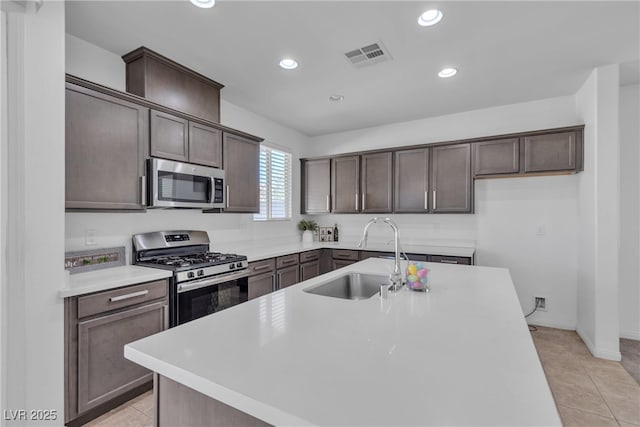 kitchen with visible vents, dark brown cabinets, recessed lighting, appliances with stainless steel finishes, and a sink