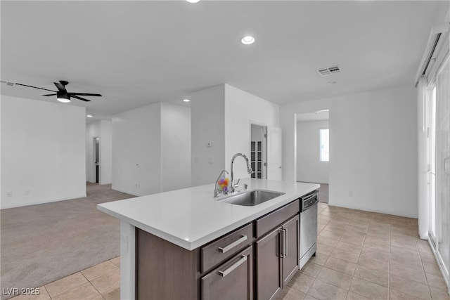 kitchen featuring visible vents, a sink, open floor plan, light countertops, and stainless steel dishwasher