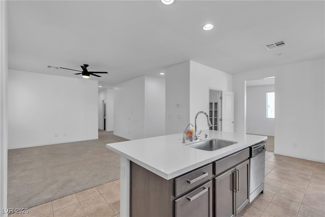 kitchen with visible vents, a sink, light carpet, dishwasher, and open floor plan